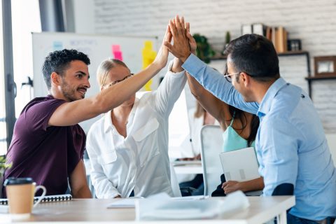 Image of a successful business team celebrating a good job.